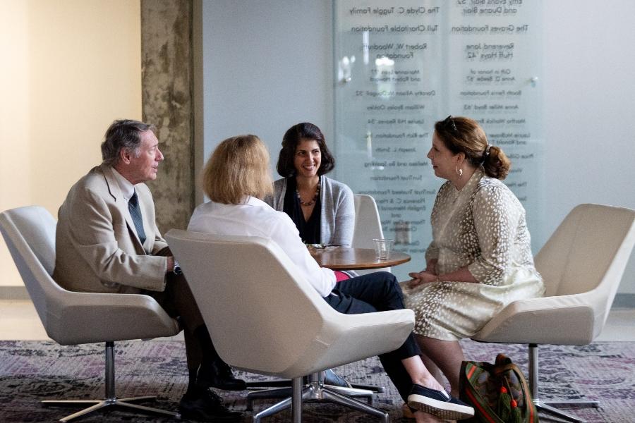 faculty talking around a table